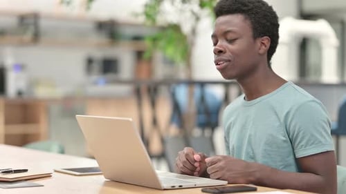 Man Having Video Call on Laptop at Desk