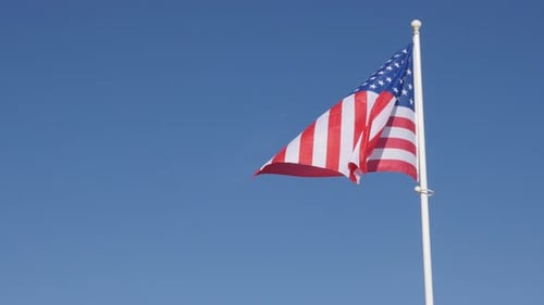 American Flag Waving Against a Blue Sky