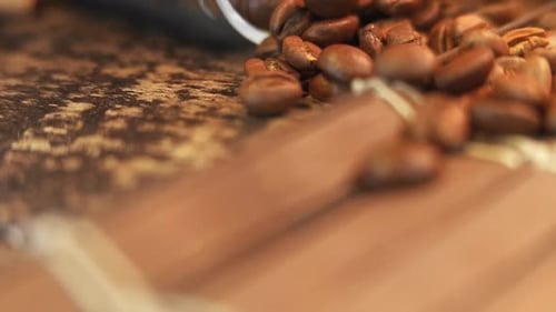 Roasted Coffee Beans Poured onto Brown Surface