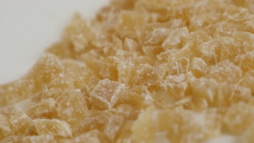 Crystallized Zingiber officinale cubes 4K 2160p 30fps UltraHD panning footage - Pile of cooked and