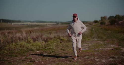Man Jogging on Rural Trail for Fitness