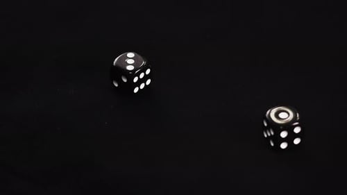 Gamer Hand Throwing Black Double Dice on Dark Background. Rolling Dice in Night Casino. Close Up