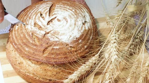 Bread Slicing Close Up with Wheat Decoration