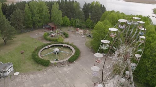 Abandoned and Forgotten Amusement Park With Swings and Carousel