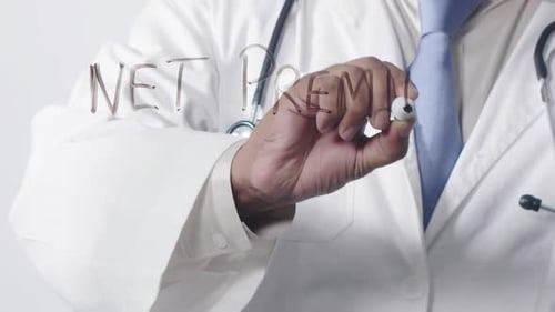 Doctor Writes "Net Premium" on Clear Surface
