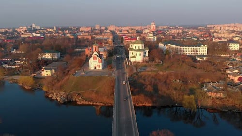 Aerial Shot of Bridge Over River and Two Churches in Small European City
