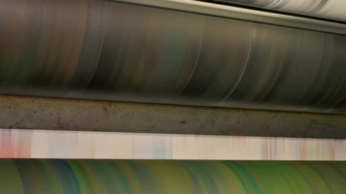 Ink rollers at high speed in a printing factory printing newspapers