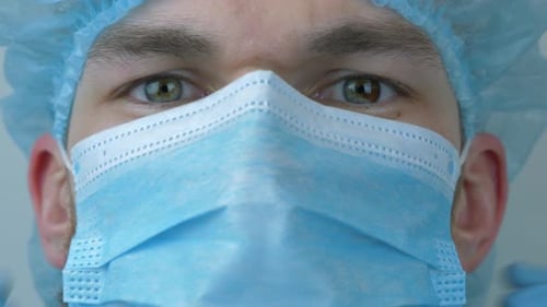 Close Up of Medical Professional Adjusting Surgical Mask