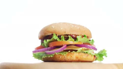 Fresh Burger With Toppings Rotating on Display