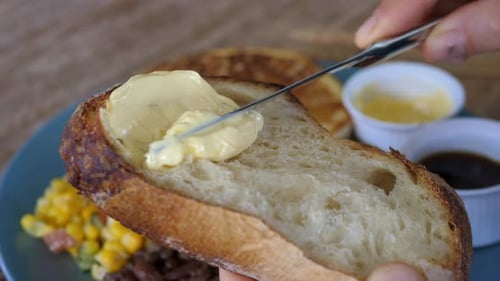 Spreading Creamy Butter on Fresh Sourdough Bread