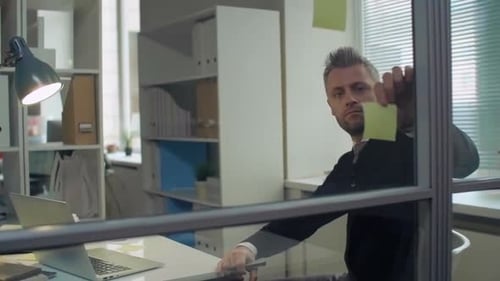 Focused Man Working Diligently in Modern Office