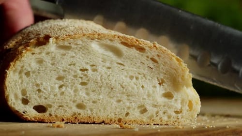 Fresh Bread Slice with Knife on Wooden Board