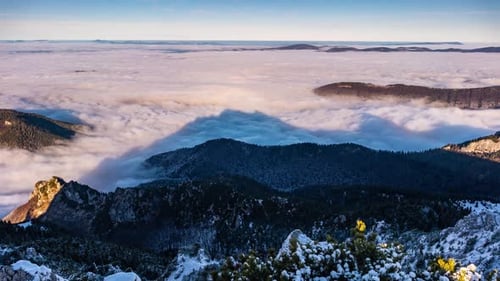 Low Foggy Clouds in Beautiful Nature Landscape in Shadow of Alpine Peak Mountain