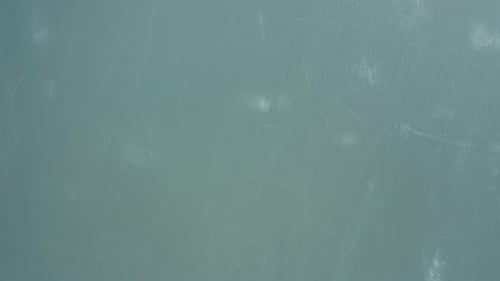 AERIAL: Very High Flight Above Frozen Solid Lake with Fractured Ice