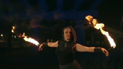 Woman Performing with Fire at Night