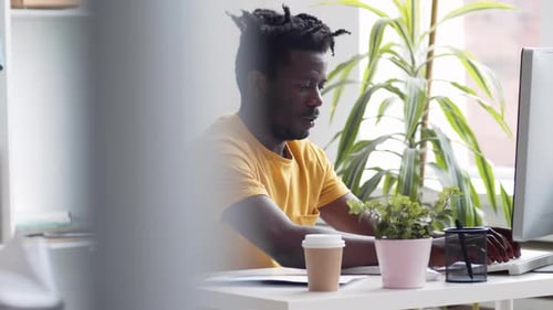 African Man Working on PC in Office