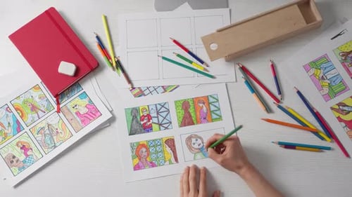 Hands Coloring in Cartoon Frame with Colored Pencil