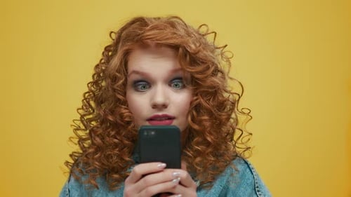 Woman Looking at Mobile Phone with Surprised Expression
