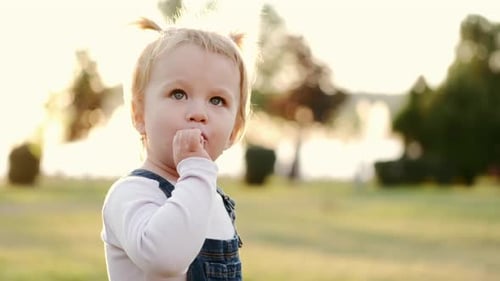 Child Enjoys a Lollipop in the Park
