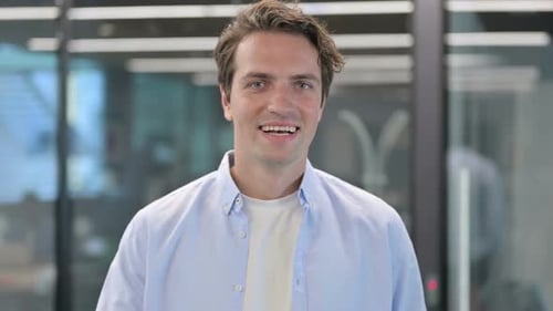 Young Adult Smiling and Giving a Thumbs Up