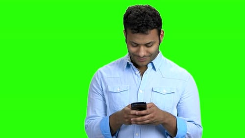 Smiling Man Texting Message on His Phone