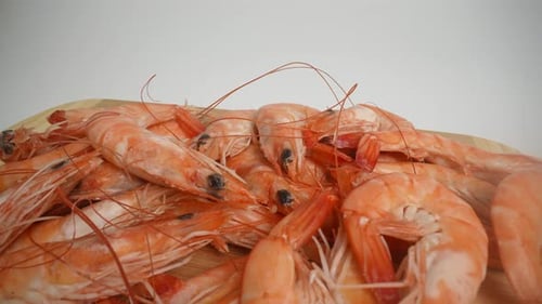 Pile of Uncooked Shrimp on a Wooden Board