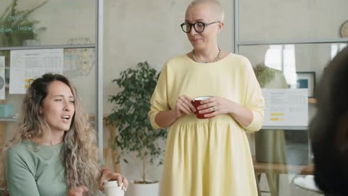 Multiethnic Coworkers Chatting on Coffee Break in Office