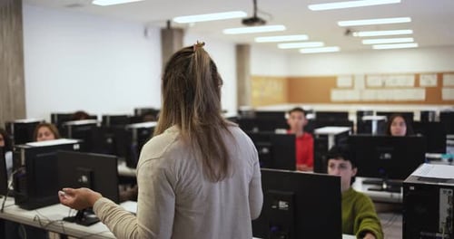 Young students using computers at school class