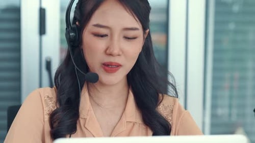 Businesswoman Wearing Headset Working Actively in Office