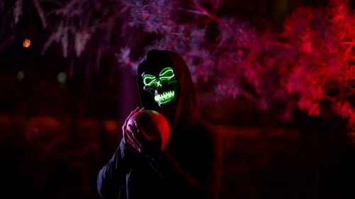 Celebration of All Hallows Eve Person in Suit of Death or Ghost with Glowing Skull Holding Pumpkin