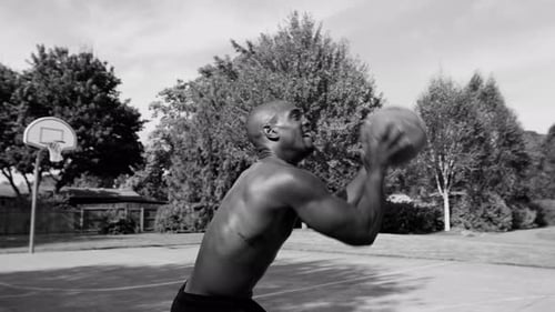 Basketball player dibbles and shoots