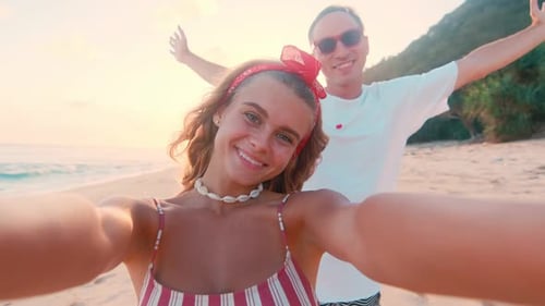 Young Joyful Caucasian Woman and Man Posing Relaxing at Summer Resort with Sea