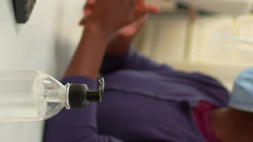 Vertical Video Close Up of Black Woman Using Hand Sanitizer in Office