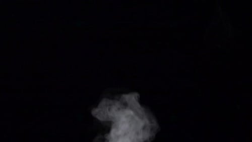 Fog Billowing Over Blurred Stream on Black Background, Slow Motion