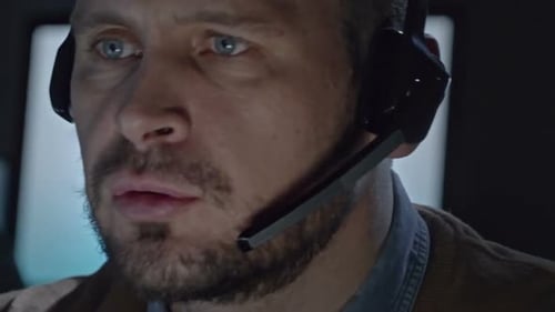Man Wearing Headset in Front of Computer