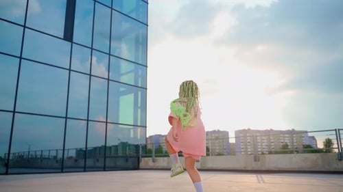 Girl dancing outdoors. Back view.Young professional dancer improvise in freestyle