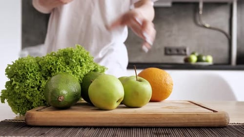 Woman selects oranges for healthy kitchen meal