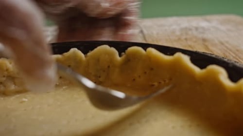 Hands Form Pie Crust Edges with Fork