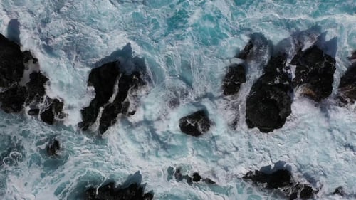 Waves of the Atlantic Ocean crash on coastal rocks