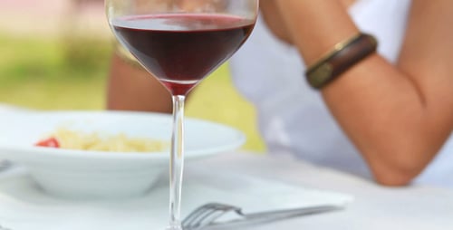 Woman Drinks Red Wine in a Restaurant