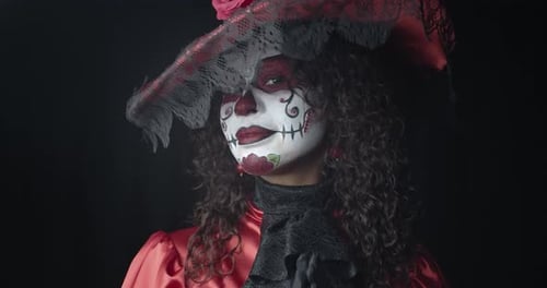 Woman in Red Dress and a Hat Wearing Skull Makeup Santa Muerte Film Grain
