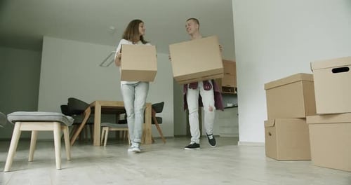 Couple Moving Boxes into New Home Together