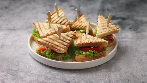 Tasty and Fresh Club Sandwich Served on White Ceramic Plate