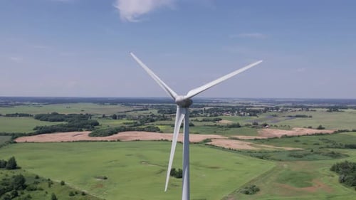 Aerial view of windmills farm for energy production on beautiful cloudy sky at highland. Wind power