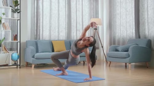 Young Asian Athletic Female Exercising, Stretching And Practicing Yoga At Home. Healthy Lifestyle