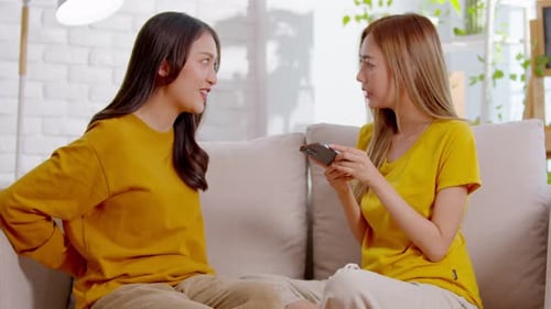 Woman Proposes to Girlfriend with Ring Indoors