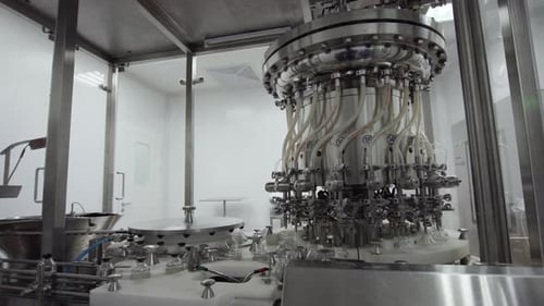 Glass Bottles on a Medical Solution Conveyor at Filling Station