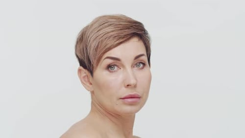 Close-up of middle aged mature woman over white background.