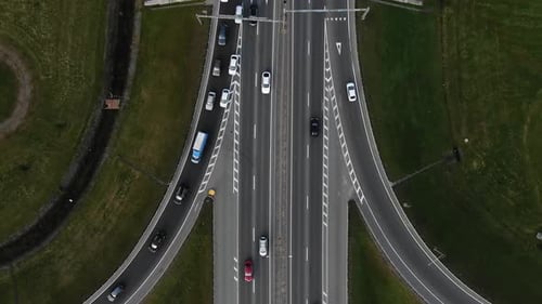 Automobiles Drive at High Speed Along Multilevel Highway