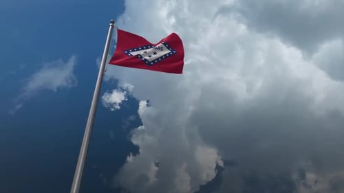 Waving Arkansas State Flag Against Blue Sky